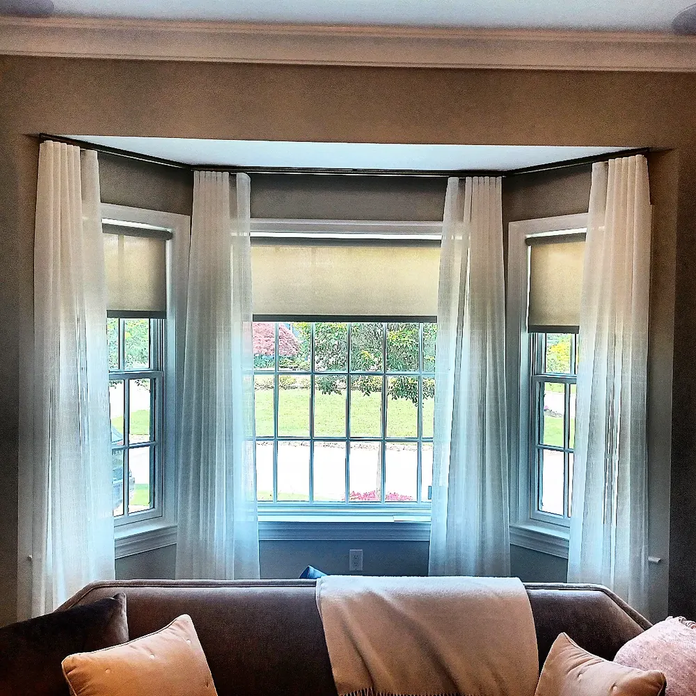 Sheer drapery with a roller shade, bay window