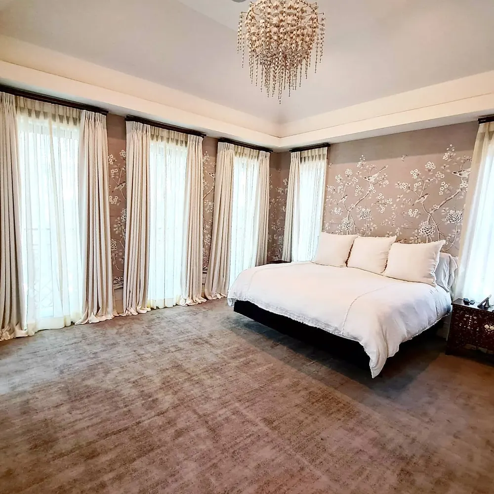 Drapery along a wall of windows, bedroom